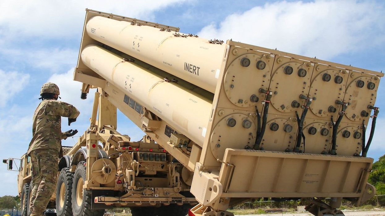 Army Cpl. Rogelio Argueta, Patriot Launching Station Enhanced Operator-Maintainer, assigned with Task Force Talon, 94th Army Air and Missile Defense Command gives commands, during a practice missile reload and unload drills on a Terminal High Altitude Area Defense (THAAD) system trainer at Andersen Air Force Base, Guam.