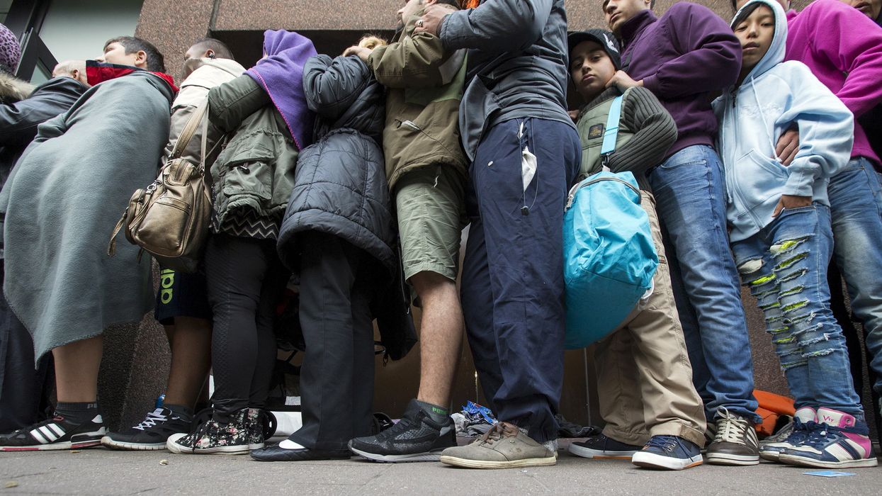 Asylum seekers wait outside the foreign office in Brussels, Belgium.