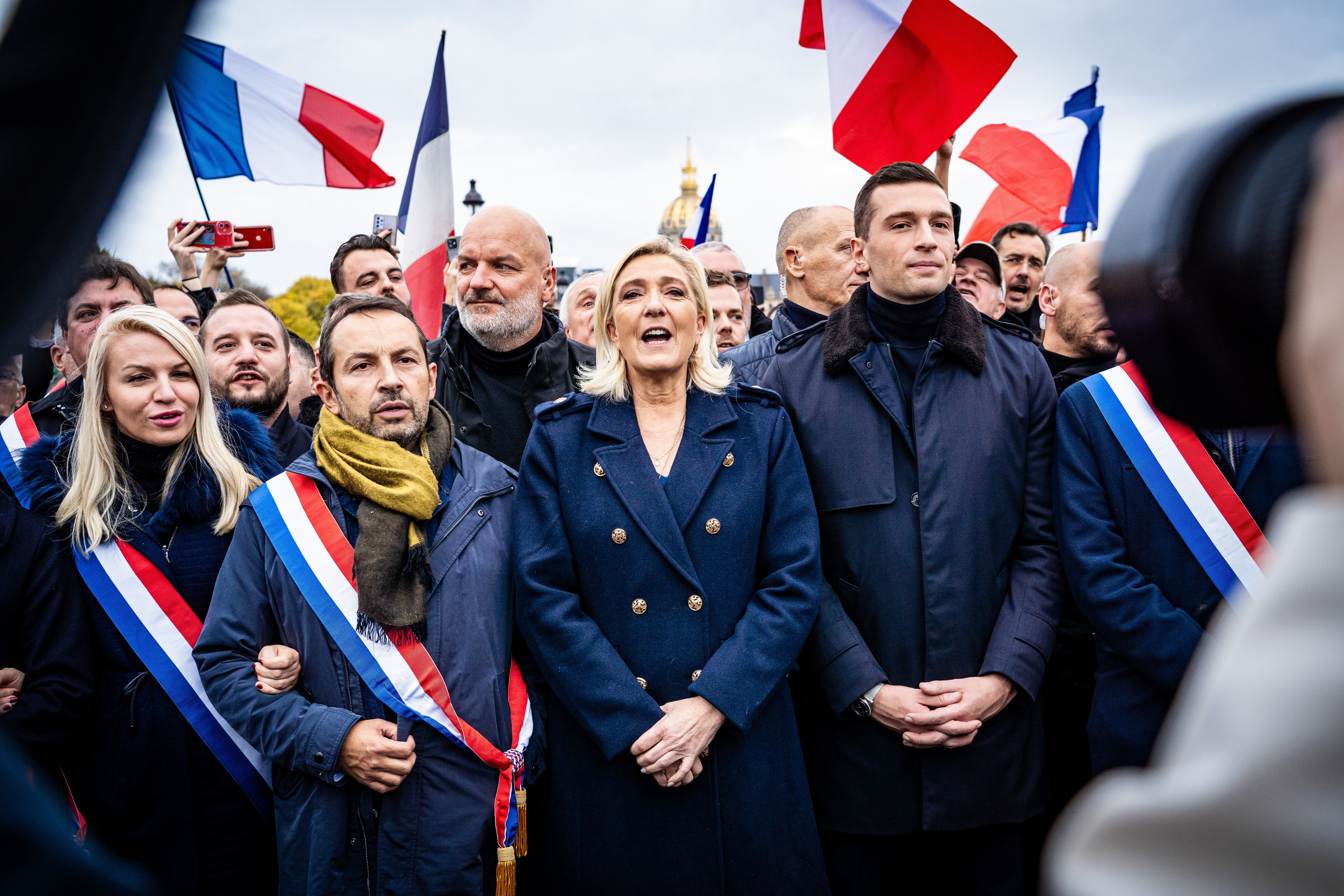 ​At a civic march against antisemitism in Paris this weekend, a far-right political procession saw Marine Le Pen, president and deputy of the Rassemblement National group (center) demonstrate along with her deputies, including Sebastien Chenu (left) and Jordan Bardella, president of the RN (right). 
