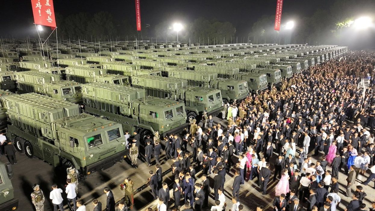 Attendees gather near tactical ballistic missile launchers during a ceremonial event to mark the delivery of new tactical ballistic missiles to North Korean troops at an undisclosed location in North Korea, August 4, 2024 in this photo released by North Korea's official Korean Central News Agency.