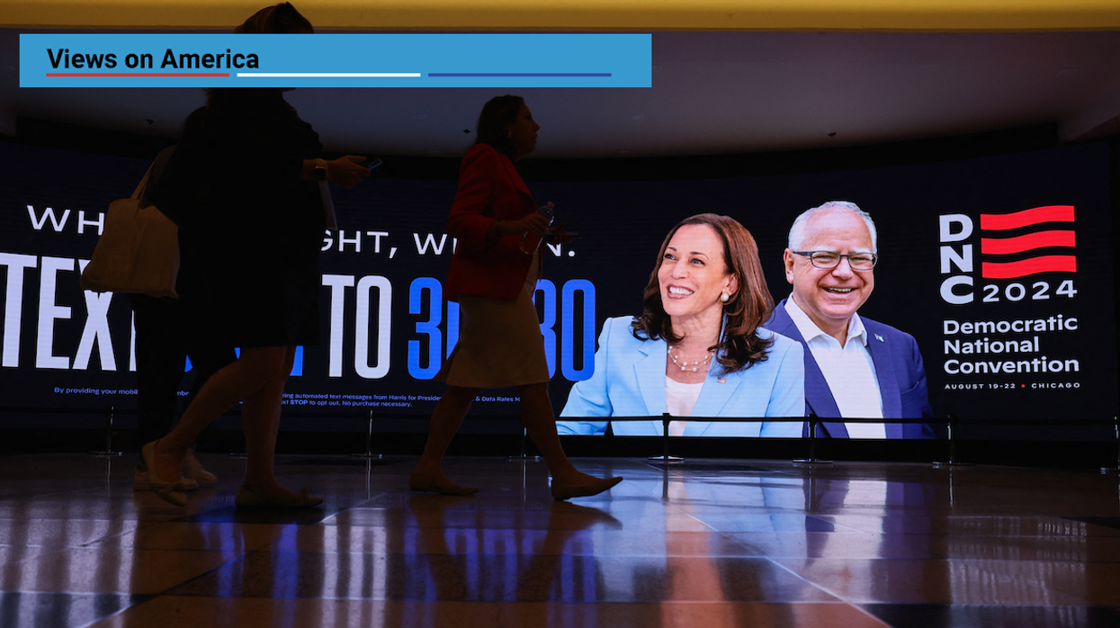 Attendees walk past a sign at the United Center ahead of the Democratic National Convention in Chicago, Illinois, on Aug. 19, 2024.