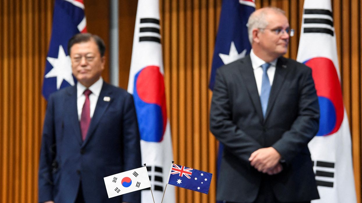 Australian and South Korean flags are pictured as Australian Prime Minister Scott Morrison and South Korean President Moon Jae-in witness a signing ceremony at Parliament House, in Canberra, Australia December 13, 2021.