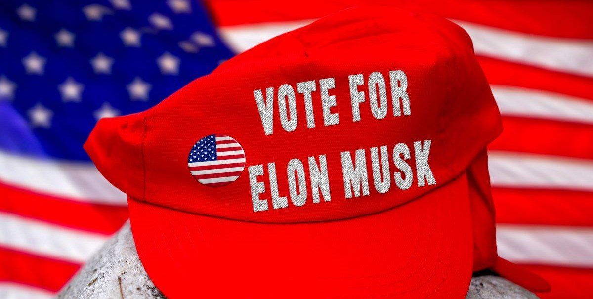 ​Bavaria, Germany - June 6, 2025: PHOTOMONTAGE, Red cap with VOTE FOR ELON MUSK in front of US flag.