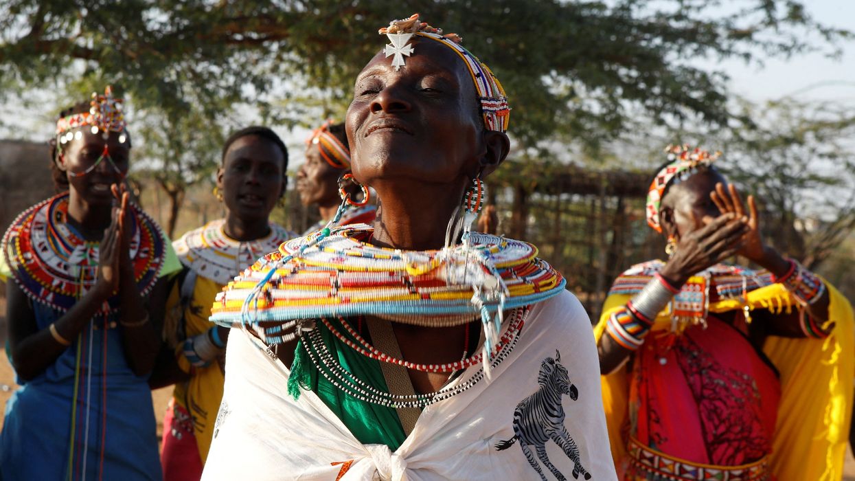 Beina Lesanjir, a woman who escaped gender based violence, participates in a traditional dance at the Umoja village, Kenya.