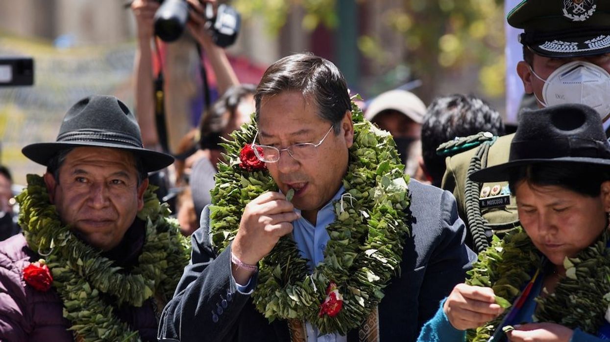 Bolivian Vice President David Choquehuanca and President Luis Arce chew coca leaves during the celebration of the "acullico" tradition, where coca leaves are shared and alternative products made with coca are shown, in La Paz, Bolivia January 11, 2023.