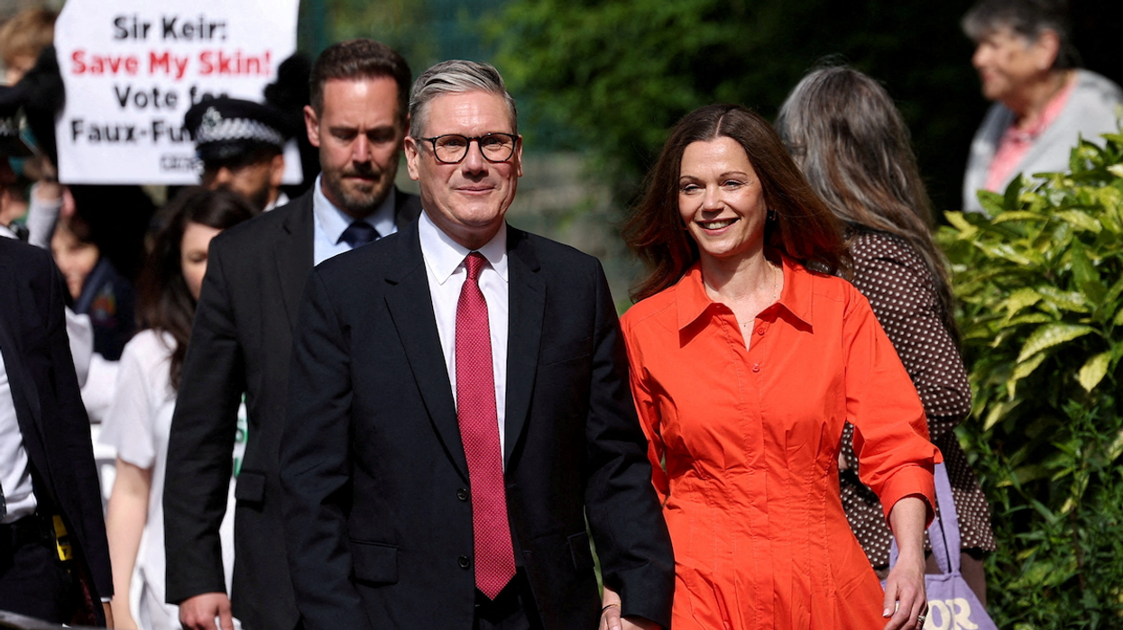 Britain's opposition Labour Party leader Keir Starmer and his wife Victoria Starmer walk outside a polling station during the general election in London, Britain, on July 4, 2024.