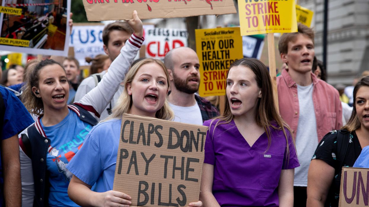 British health workers protest to demand a pay rise outside Downing St. in London.