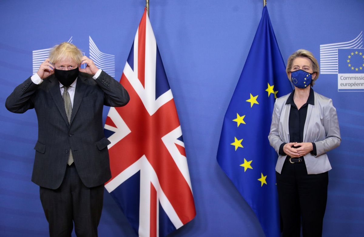British Prime Minister Boris Johnson adjusts his face mask as he meets European Commission President Ursula von der Leyen in Brussels, Belgium December 9, 2020.