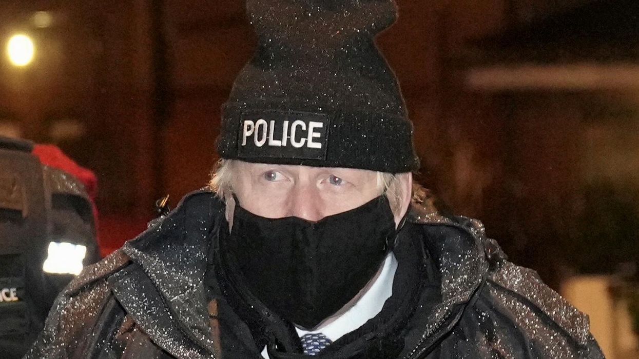 British Prime Minister Boris Johnson observes an early morning Merseyside police raid on a home in Liverpool as part of 'Operation Toxic' to infiltrate County Lines drug dealings in Liverpool, Britain December 6, 2021.