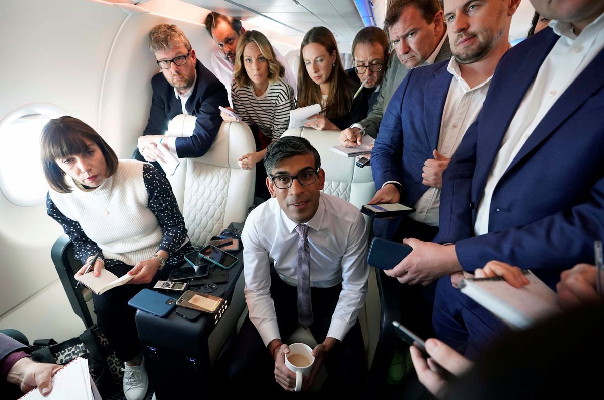 British Prime Minister Rishi Sunak holds a huddle with political journalists on board a government plane as he heads to Washington.