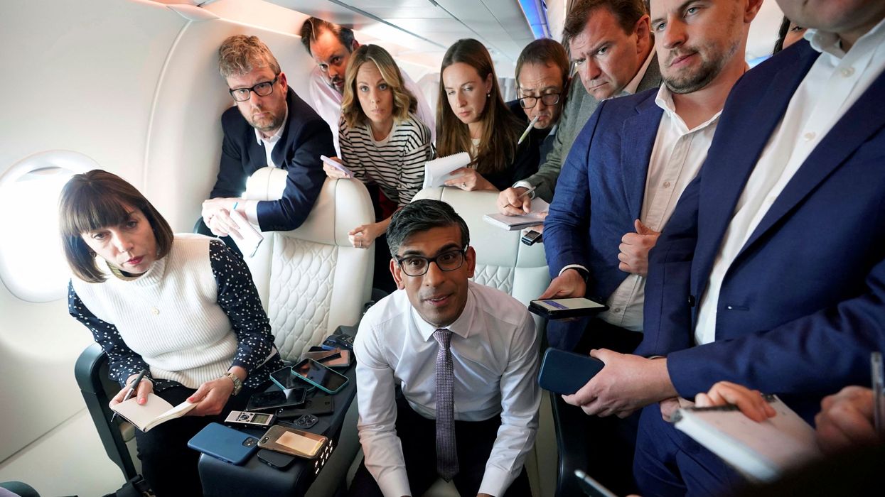British Prime Minister Rishi Sunak holds a huddle with political journalists on board a government plane as he heads to Washington.