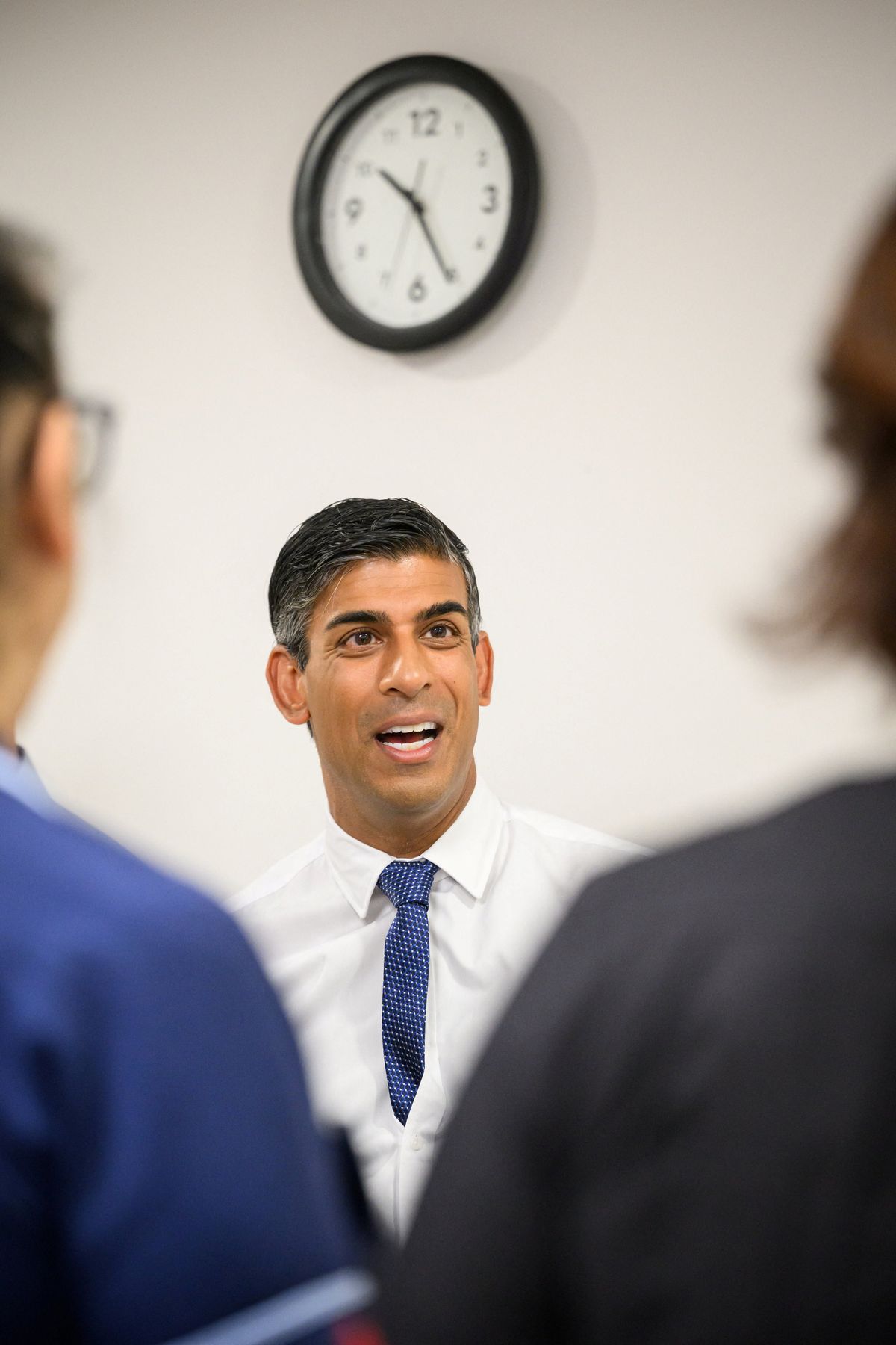 ​British Prime Minister Rishi Sunak speaks to members of staff during a visit to a regional hospital. 