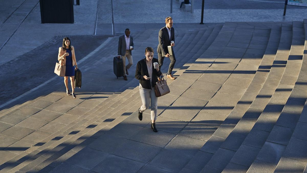 Business employees going to work. Bank of America raises minimum wage to $25 per hour by 2025