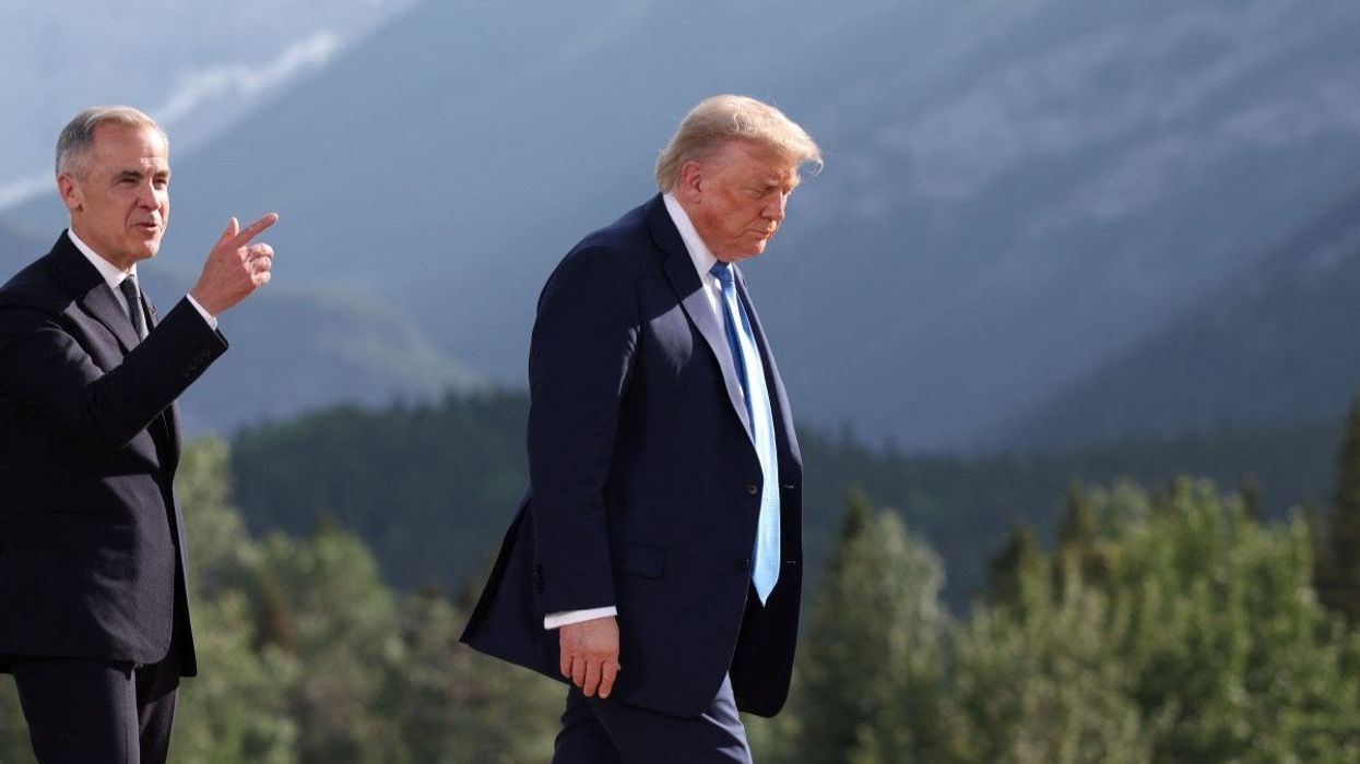 Canada's Prime Minister Mark Carney and U.S. President Donald Trump leave after a family photo session during the G7 Summit, in Kananaskis, Alberta, Canada.