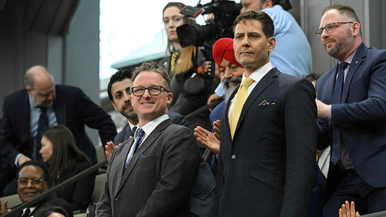 Canadians Michael Kovrig and Michael Spavor stand as they are recognized before an address from US President Joe Biden in the Canadian House of Commons on Parliament Hill, in Ottawa, Canada, March 24, 2023.