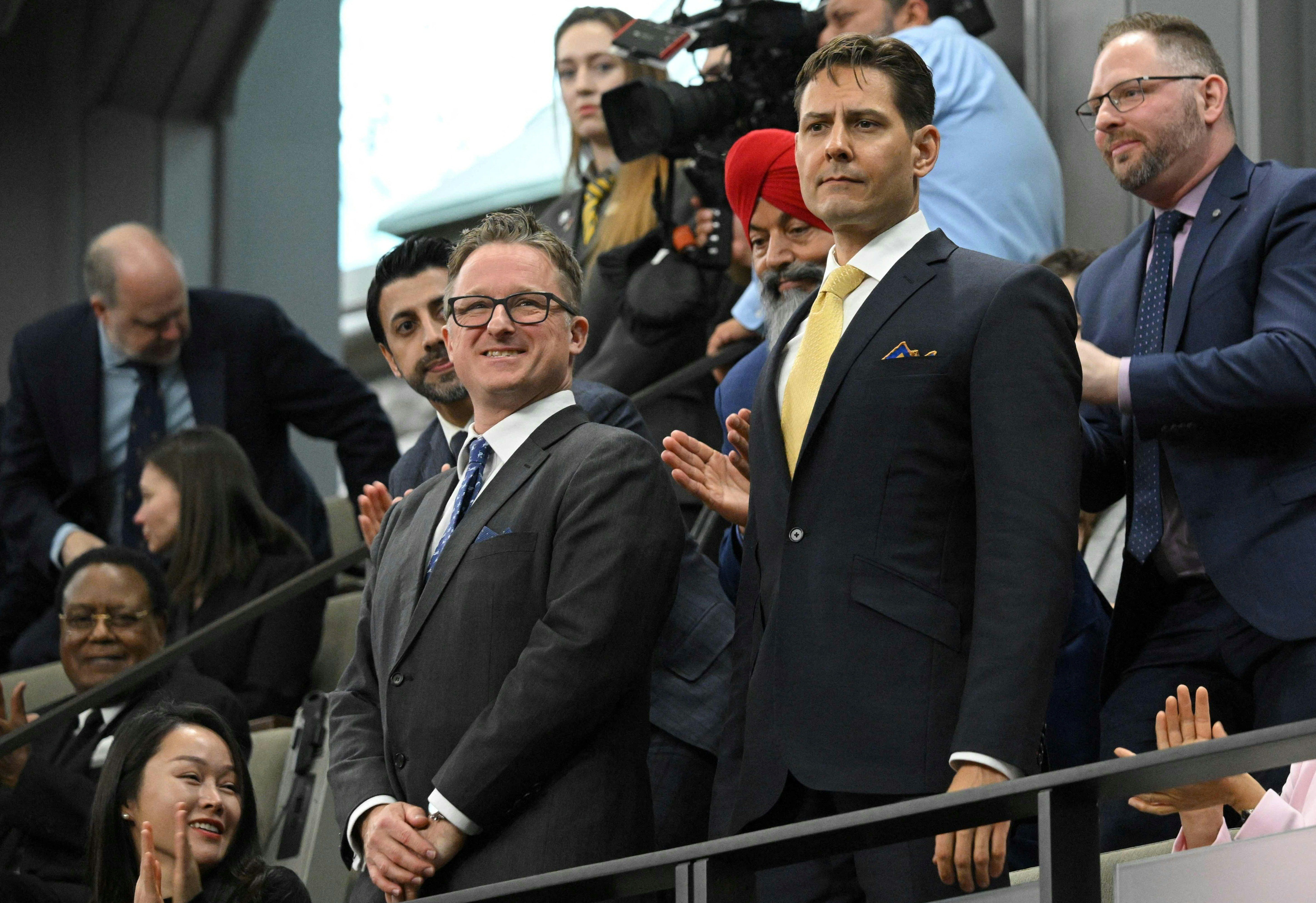 Canadians Michael Kovrig and Michael Spavor stand as they are recognized before an address from US President Joe Biden in the Canadian House of Commons on Parliament Hill, in Ottawa, Canada, March 24, 2023.