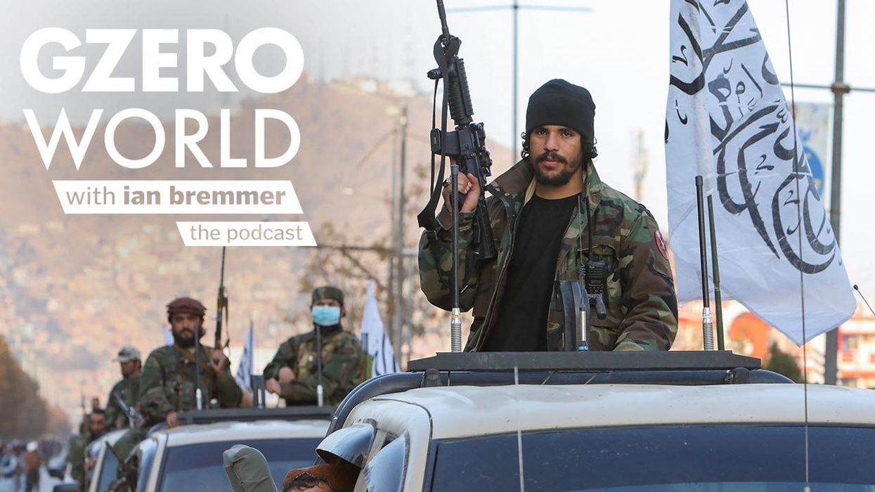 Caravan of Taliban soldiers with guns held upright