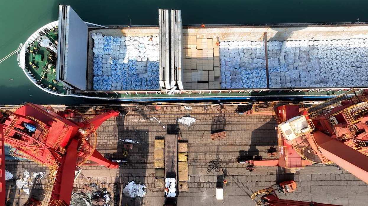 Cargo ships are unloading newly arrived chemical fertilizers at the port terminal in Lianyungang, East China's Jiangsu province, on February 27, 2024. 