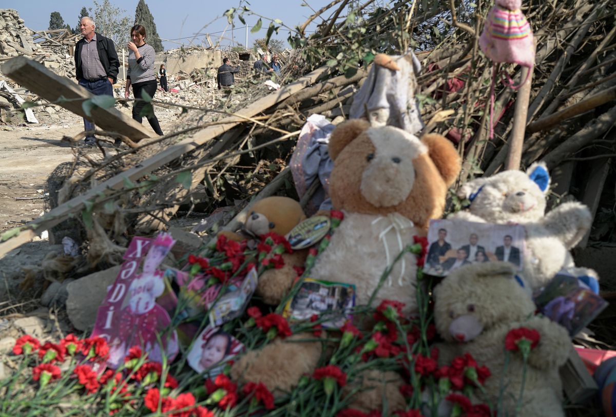 Carnations, teddy bears and pictures are laid to the blast site hit by a rocket attack in the city of Ganja, Azerbaijan. Reuters