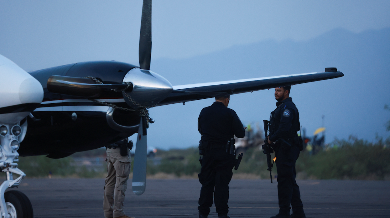 CBP agents stand by a plane that's believed to have carried Mexican drug lord Ismael "El Mayo" Zambada and Joaquin Guzman Lopez, who were arrested in El Paso, Texas.