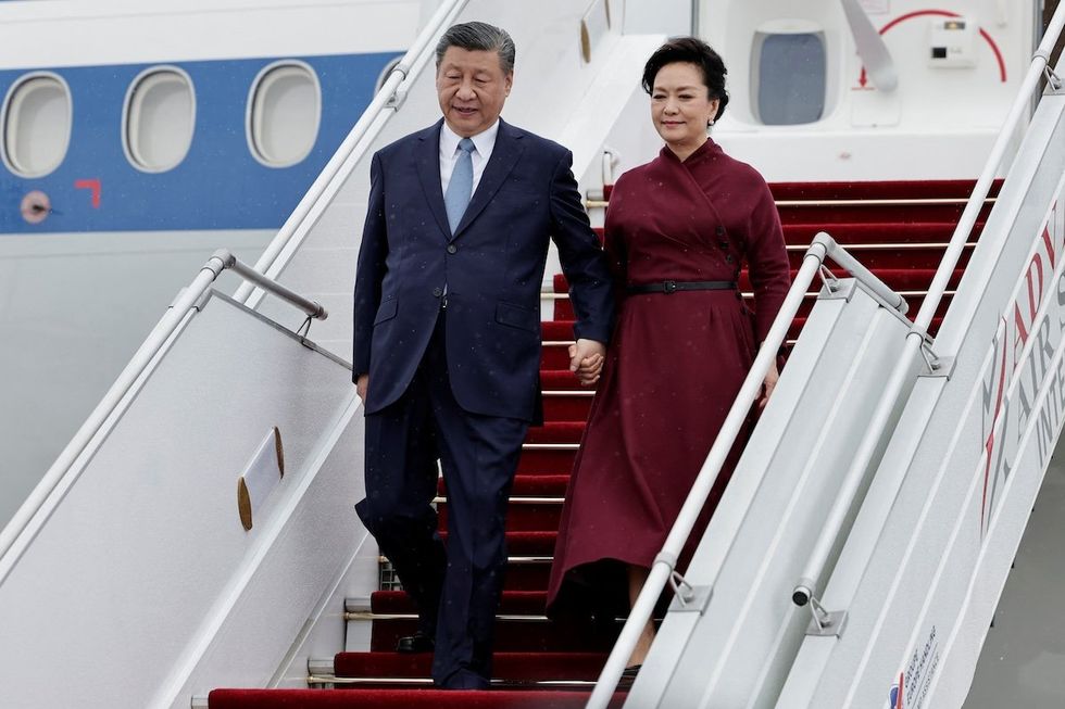​China's President Xi Jinping and his wife Peng Liyuan disembark at Orly Airport, south of Paris, on May 5, 2024. 