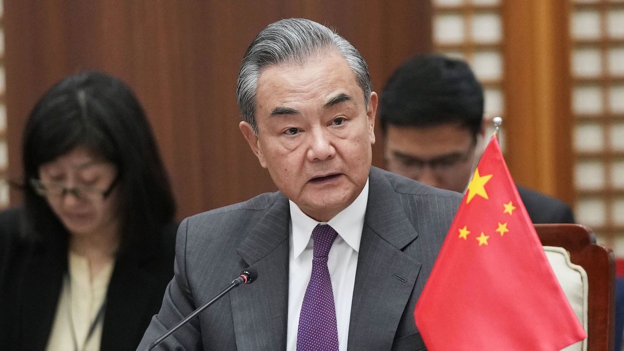 China's top diplomat Wang Yi speaks at a meeting with his Japanese and South Korean counterparts, Yoko Kamikawa and Park Jin, in Busan, South Korea, on Nov. 26, 2023.