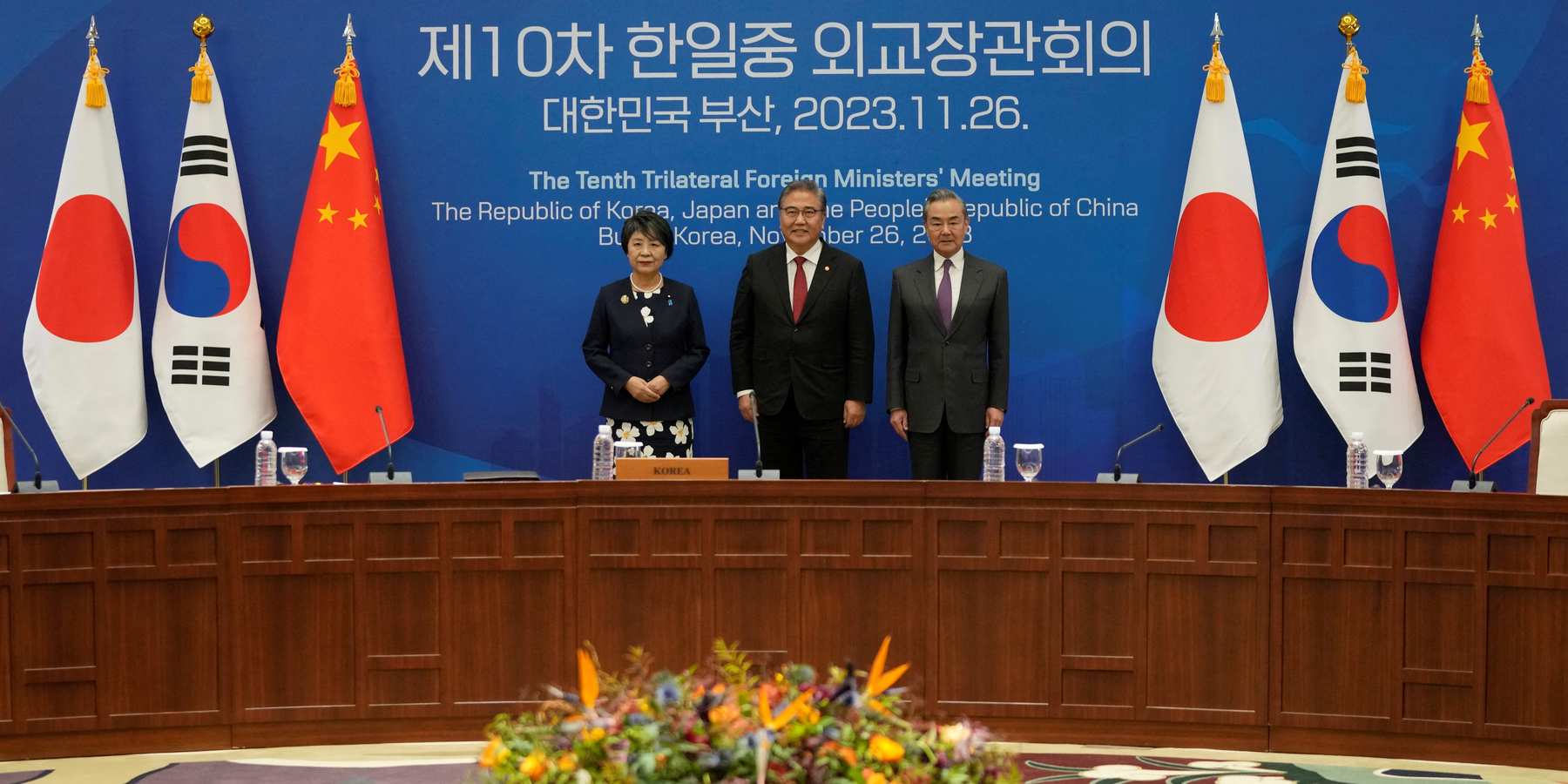 Chinese Foreign Minister Wang Yi, South Korean Foreign Minister Park Jin, and Japanese Foreign Minister Yoko Kamikawa pose for a photo prior to the 10th trilateral foreign ministers' meeting in Busan, South Korea, Sunday, Nov. 26, 2023.