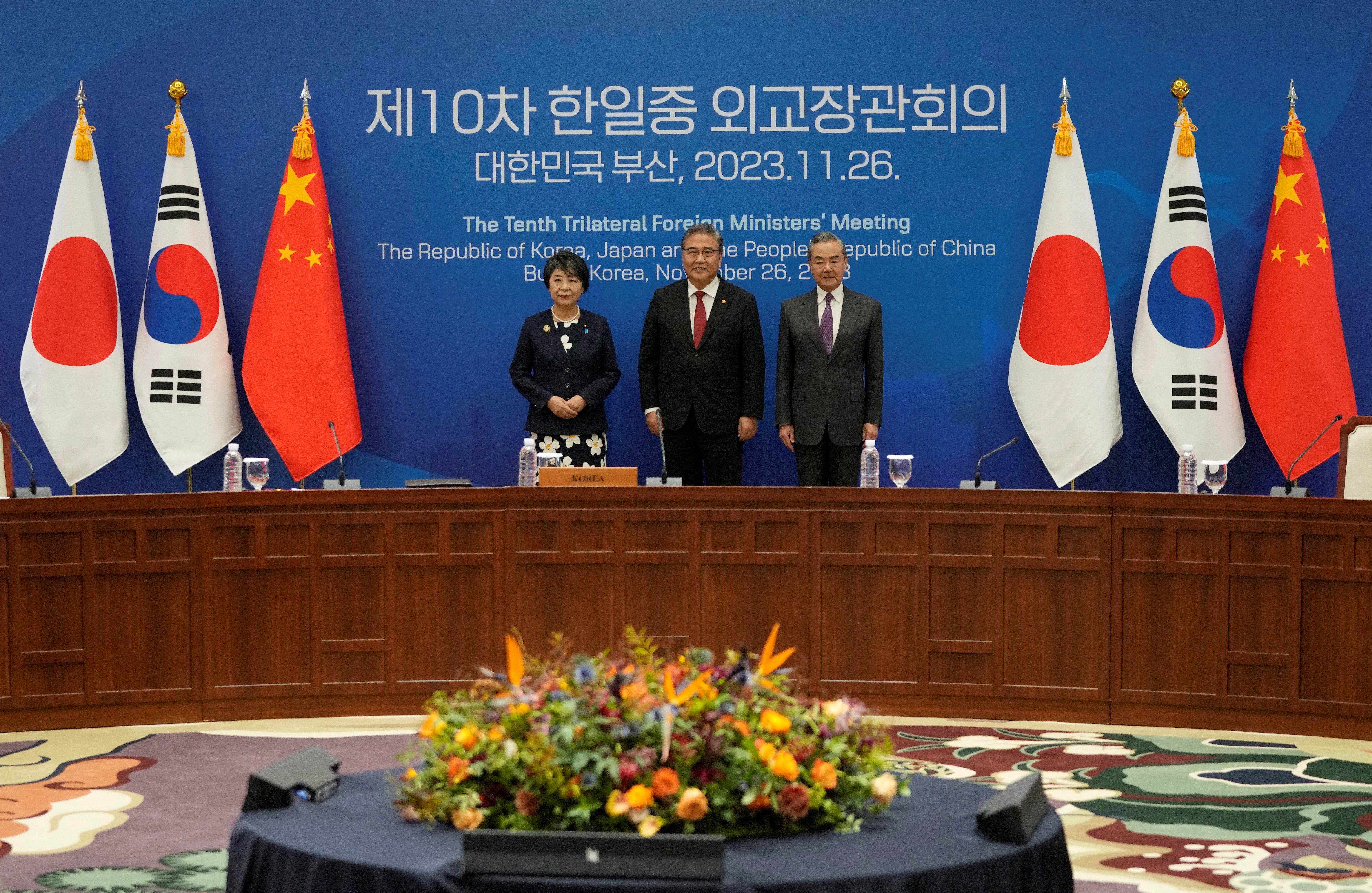 Chinese Foreign Minister Wang Yi, South Korean Foreign Minister Park Jin, and Japanese Foreign Minister Yoko Kamikawa pose for a photo prior to the 10th trilateral foreign ministers' meeting in Busan, South Korea, Sunday, Nov. 26, 2023.