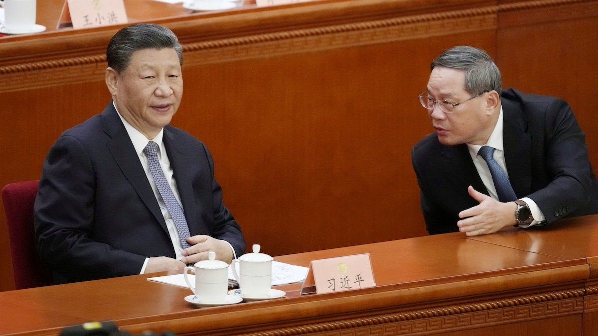 Chinese President Xi Jinping (L) converses with Premier Li Qiang on the first day of a weeklong meeting of the Chinese People's Political Consultative Conference, China's top political advisory body, at the Great Hall of the People in Beijing on March 4, 2024.