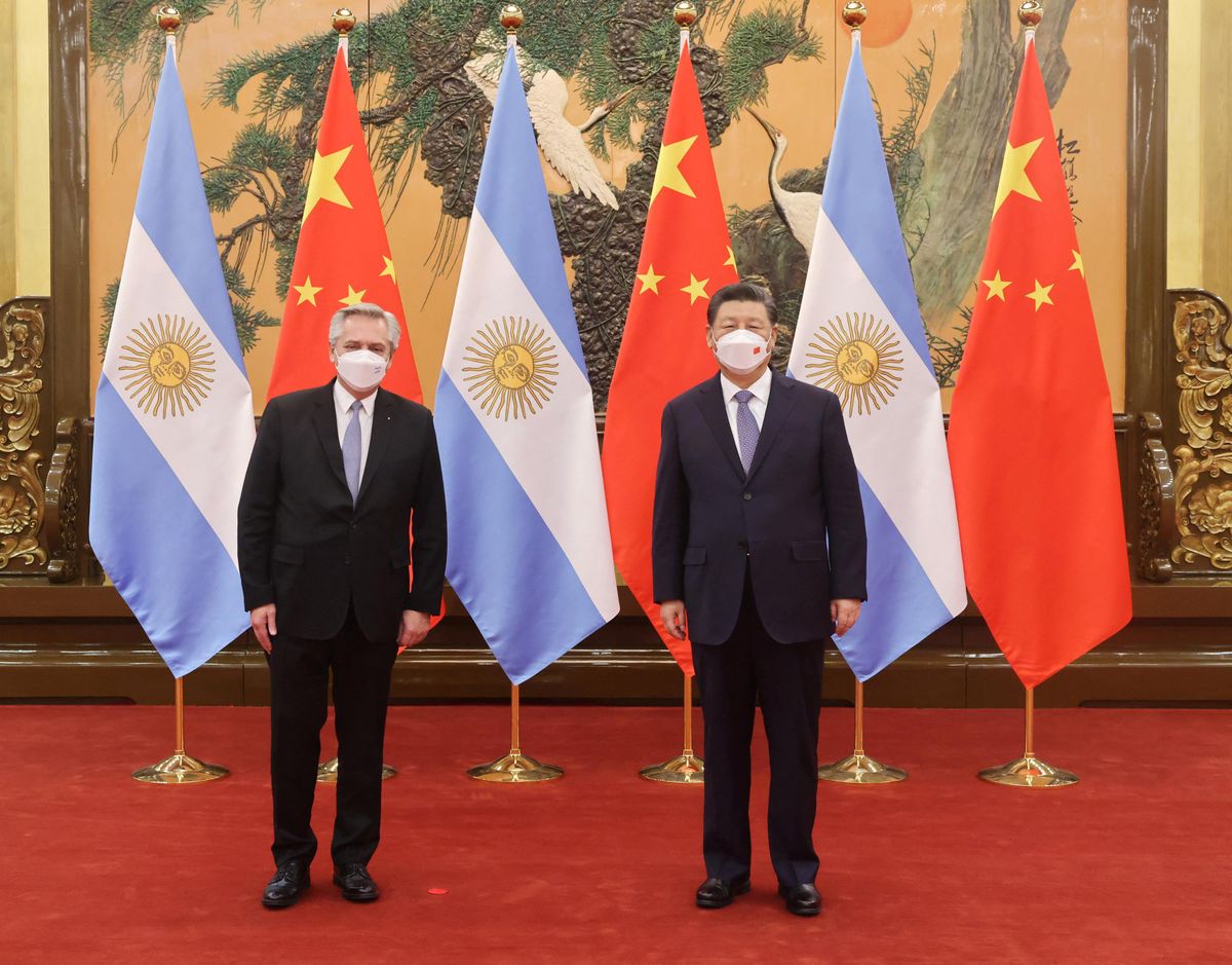 Chinese President Xi Jinping stands next to Argentina's President Alberto Fernandez during their meeting in Beijing