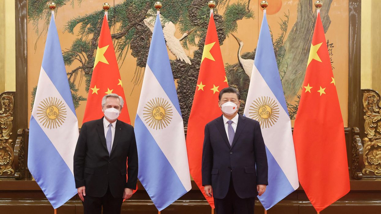 Chinese President Xi Jinping stands next to Argentina's President Alberto Fernandez during their meeting in Beijing