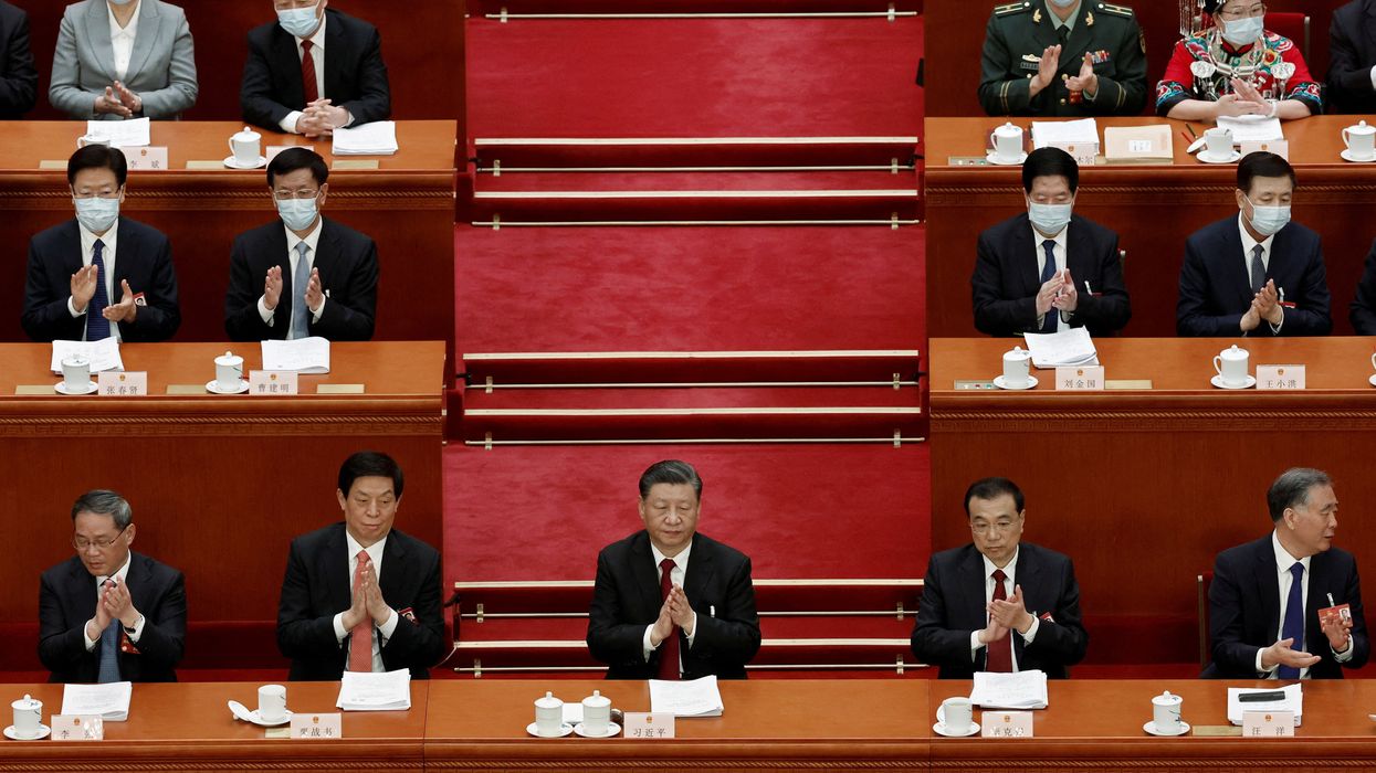 Chinese President Xi Jinping surrounded by other members of the Chinese government at the Great Hall of the People in Beijing, China March 5, 2023.