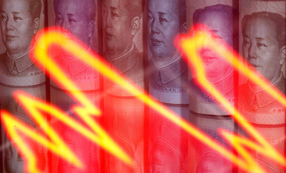 Chinese Yuan banknotes are seen behind illuminated stock graph in this illustration taken February 10, 2020.