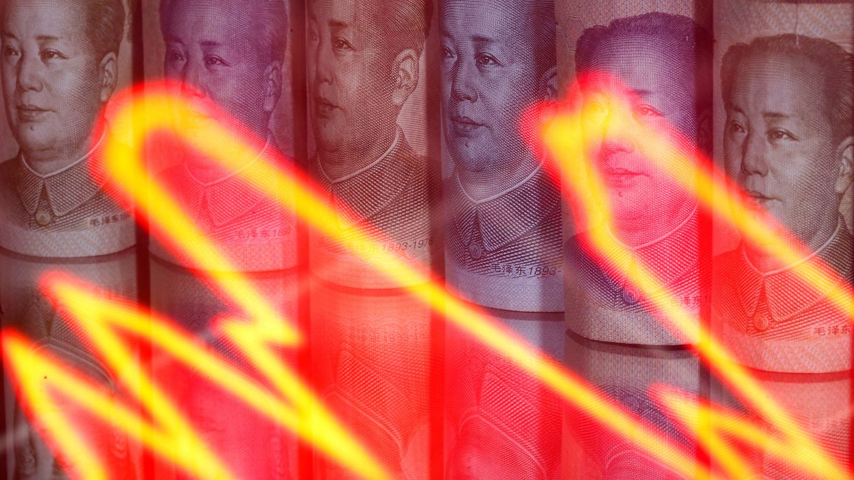 Chinese Yuan banknotes are seen behind illuminated stock graph in this illustration taken February 10, 2020.