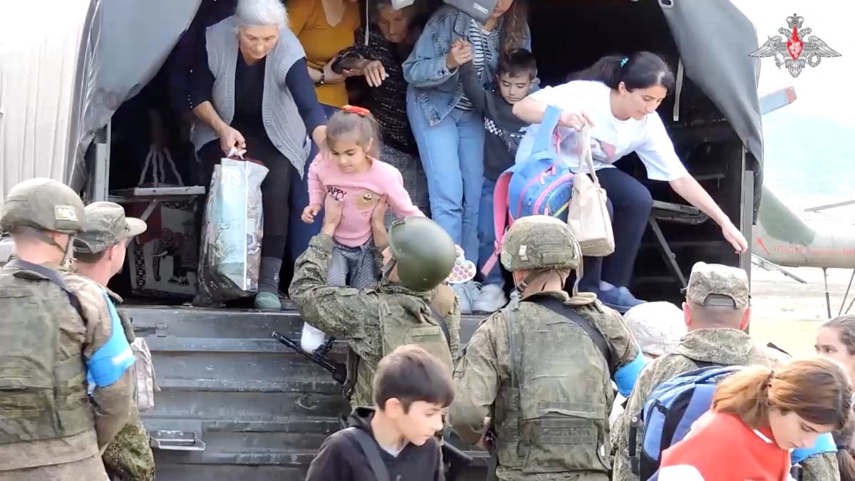 Civilians get out of a truck during an evacuation performed by Russian peacekeepers at an unknown location following the launch of a military operation by Azerbaijani forces in Nagorno-Karabakh, a region inhabited by ethnic Armenians, in this still image from video published September 20, 2023.