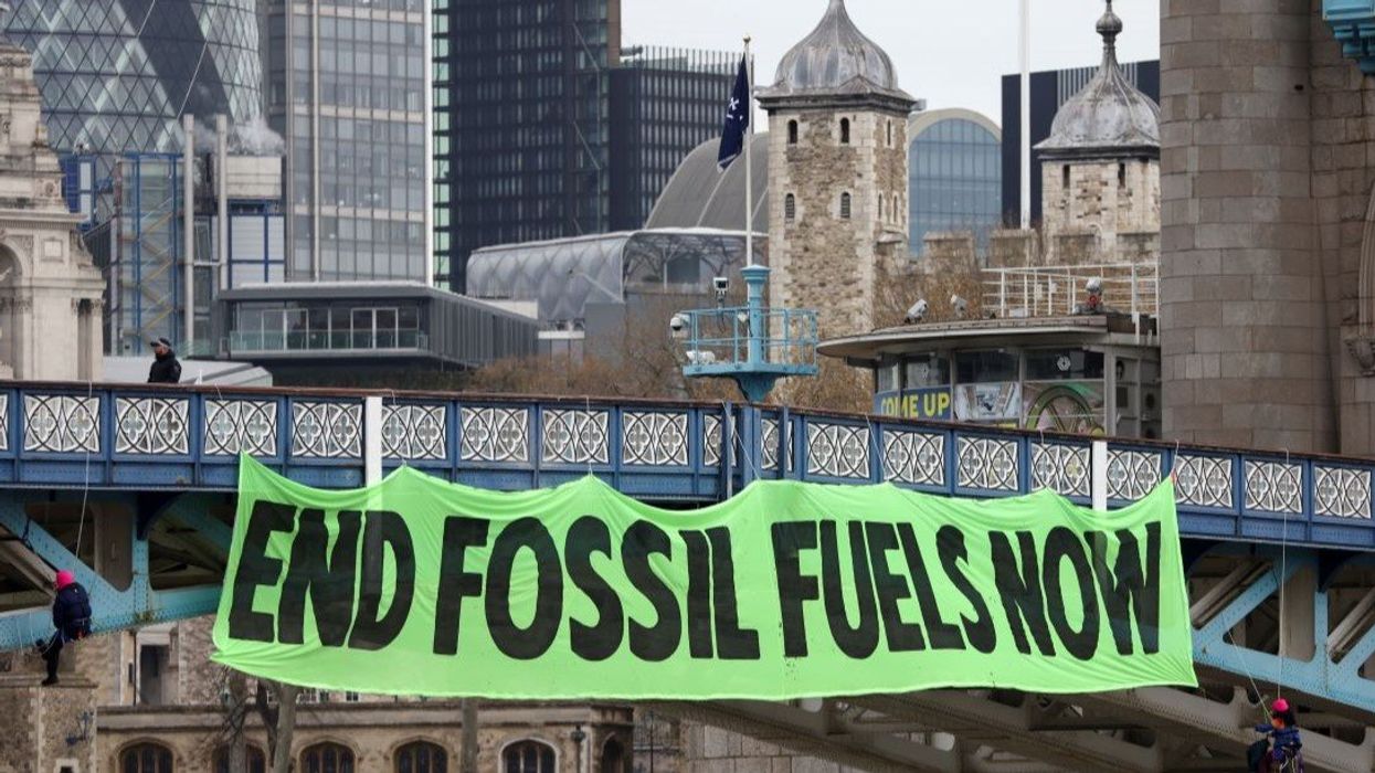 Climate change activists hang a sign on Tower Bridge during a demonstration against the climate crisis, in central London, Britain, April 8, 2022.