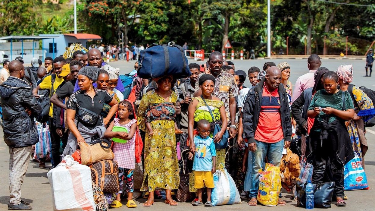 Congolese civilians who fled from Bukavu, eastern Democratic Republic of Congo, following clashes between M23 rebels and the Armed Forces of the Democratic Republic of the Congo, carry their belongings as they gather at the Rusizi border crossing point to return home, in Rusizi district, Rwanda, on Feb. 17, 2025.
