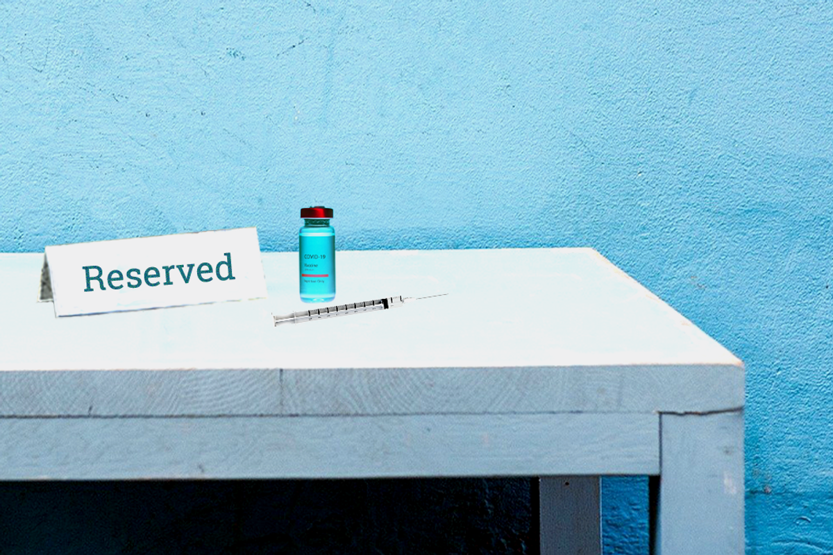COVID vaccine vile and needle next to a placard that says "reserved" 