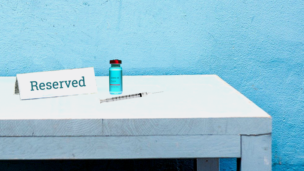 COVID vaccine vile and needle next to a placard that says "reserved"