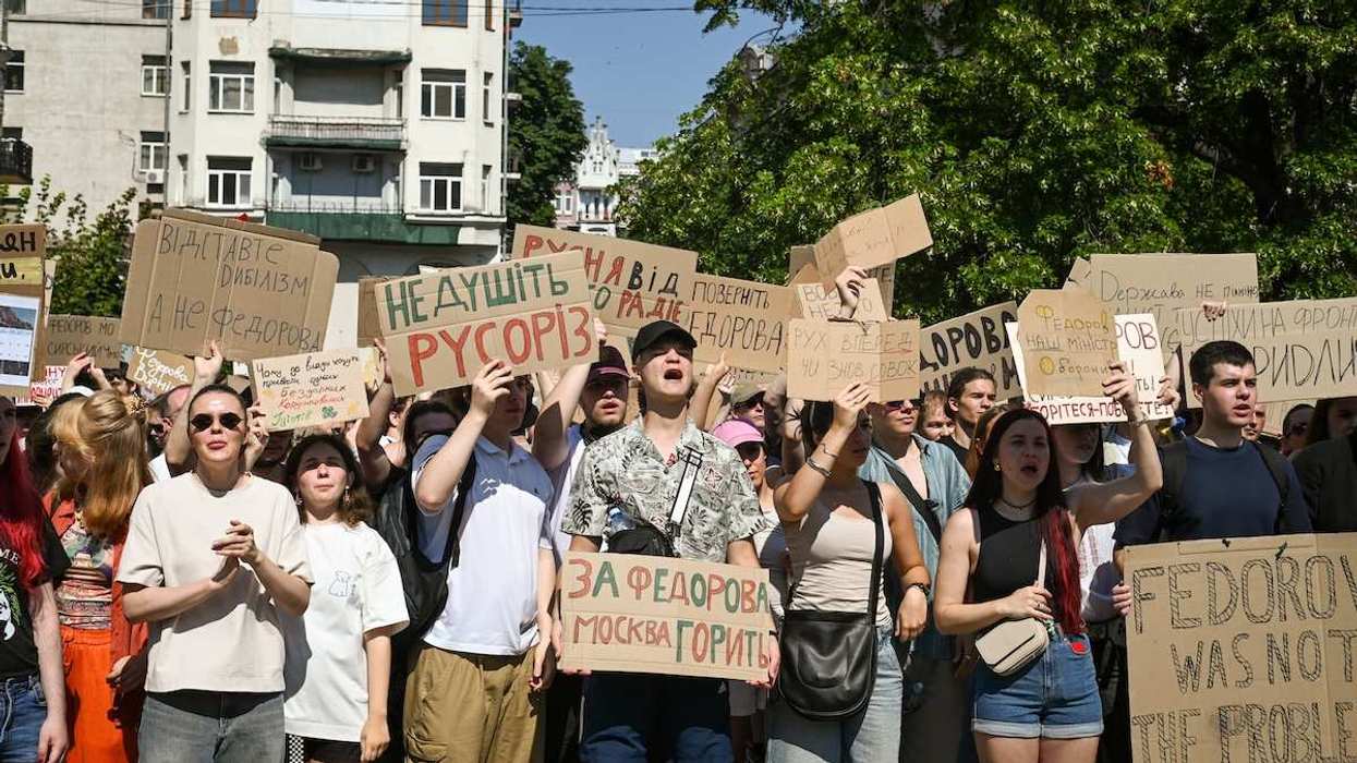 Crowds carry signs and chant during a protest in Kyiv, Ukraine to protest the dismissal of the Ukrainian Minister of Defense Mykhailo Fedorov by President Volodymyr Zelenskyy.