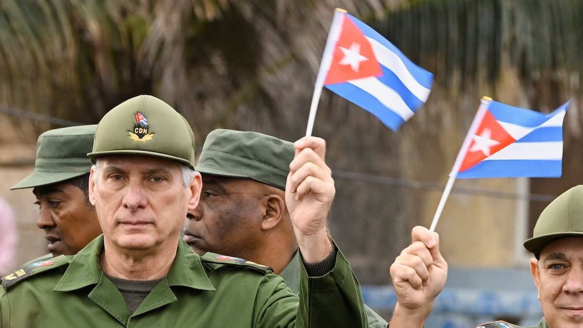 Cuba's President Miguel Diaz-Canel waves a Cuban flag during a march outside the US Embassy in Havana, Cuba, on January 16, 2026.​
