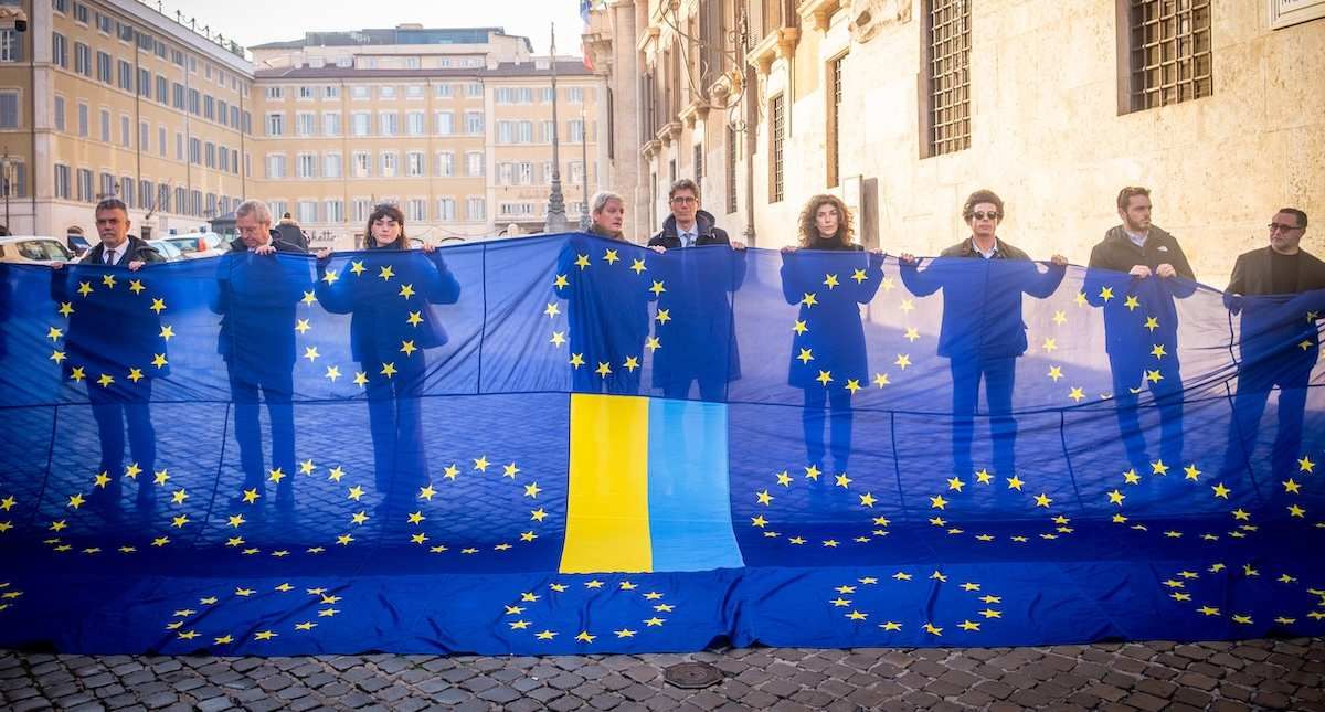 December 9, 2025, Rome, Italy: Italian politicians from parties +Europa, Democratic Party, Azione, Europa Now gather to welcome Ukraines President Zelensky with a banner made up of 27 EU flags and the Ukrainian flag.