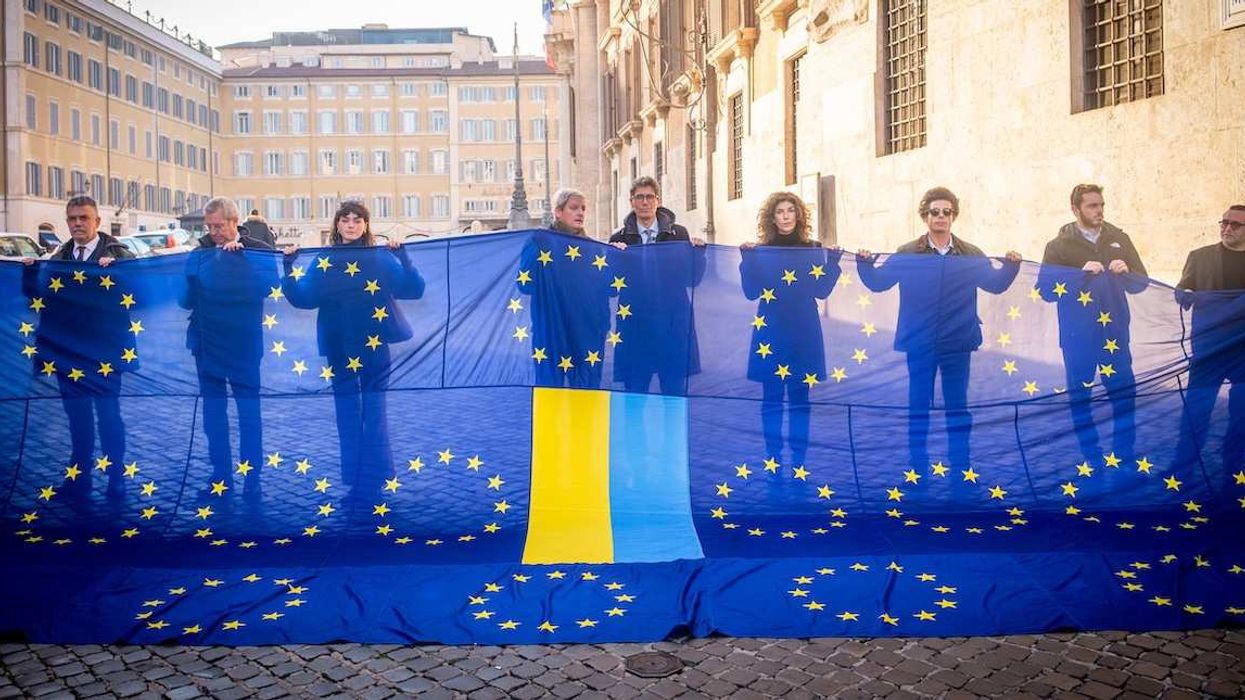 December 9, 2025, Rome, Italy: Italian politicians from parties +Europa, Democratic Party, Azione, Europa Now gather to welcome Ukraines President Zelensky with a banner made up of 27 EU flags and the Ukrainian flag.