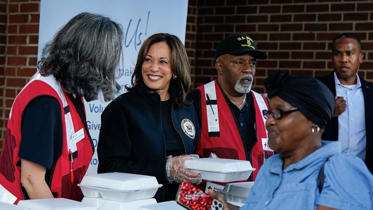 Democratic presidential nominee and US Vice President Kamala Harris helps out at a food distribution center during a visit to storm-damaged areas in the wake of Hurricane Helene, in Augusta, Ga., on Oct. 2, 2024.