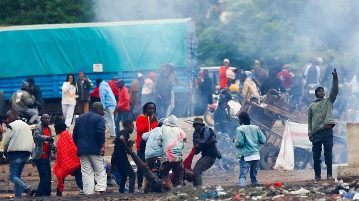 Demonstrators carry the dead body of a man killed during a protest a day after a general election marred by violent demonstrations over the exclusion of two leading opposition candidates at the Namanga One-Post Border crossing point between Kenya and Tanzania, as seen from Namanga, Kenya October 30, 2025.
