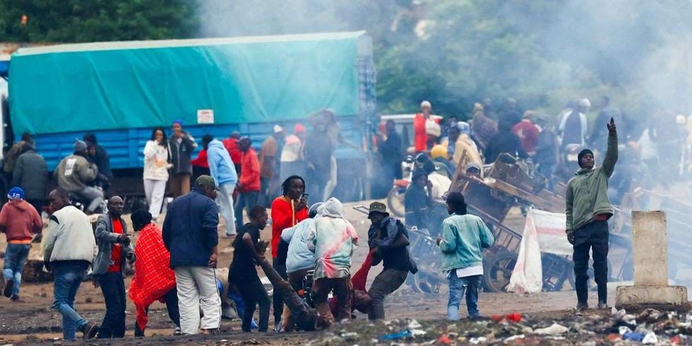 Demonstrators carry the dead body of a man killed during a protest a day after a general election marred by violent demonstrations over the exclusion of two leading opposition candidates at the Namanga One-Post Border crossing point between Kenya and Tanzania, as seen from Namanga, Kenya October 30, 2025.
