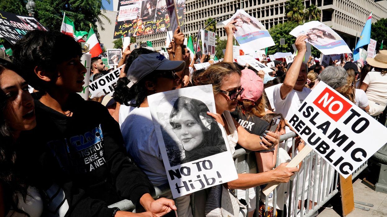 Demonstrators display images of Mahsa Amini, who died in policy custody in Tehran in Sept. 2022.