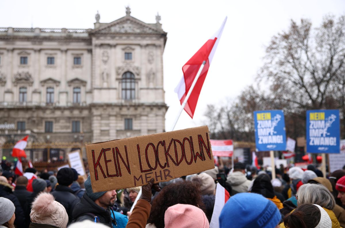 Demonstrators hold flags and placards as they march to protest against the coronavirus disease (COVID-19) restrictions and the mandatory vaccination in Vienna, Austria, December 4, 2021. 