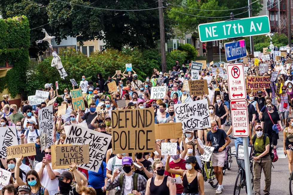 Demonstrators march to defund the Minneapolis Police Department following the murder of George Floyd.