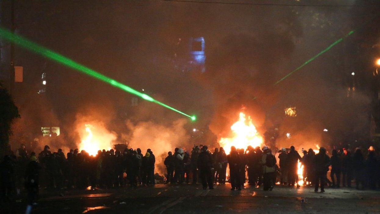 Demonstrators stand next to a fire during a protest against the new government's decision to suspend the European Union accession talks and refuse budgetary grants until 2028, in Tbilisi, Georgia December 2, 2024.